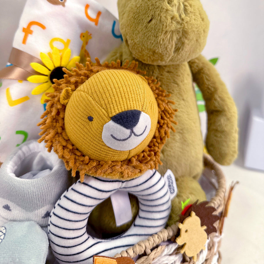 A VWOWGIFTS JUNGLE ADVENTURE BABY HAMPER with a teddy bear and a lion.