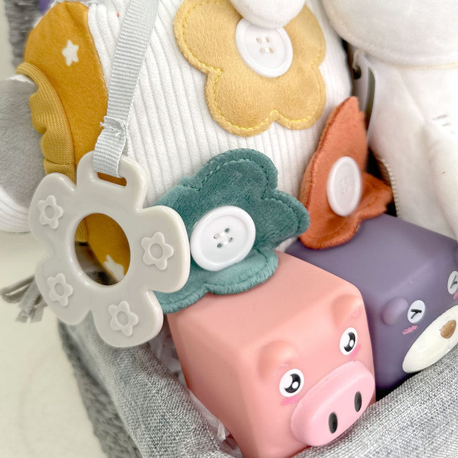 A basket filled with VWOWGIFTS' BABY'S FIRST GIFT SET toys and stuffed animals, perfect for baby gifts.