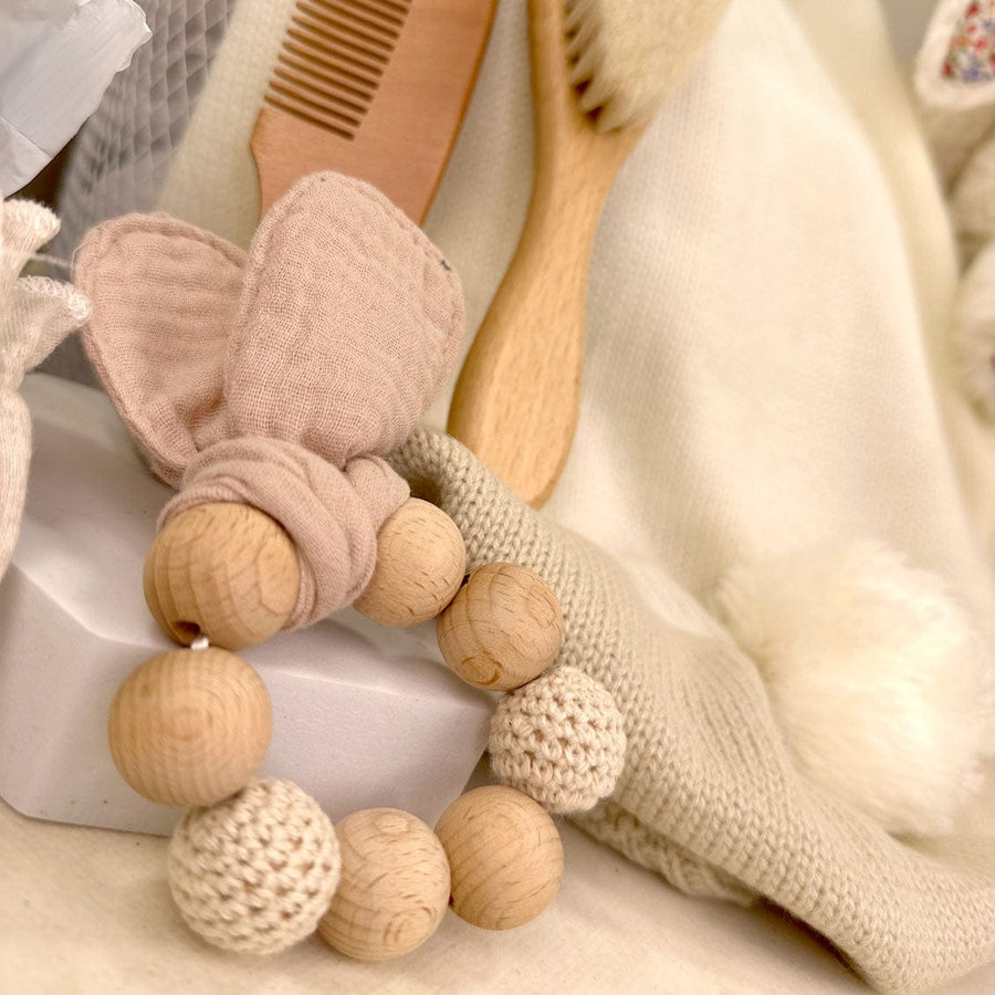 An ENCHANTED BABY GIFT SET by VWOWGIFTS, including wooden teething beads and a comb, perfect for a newborn.