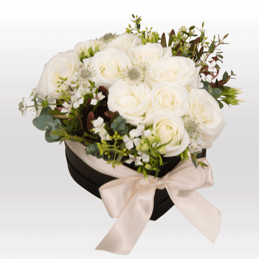 An arrangement of PURE LOVE white roses in a black box by VWOWGIFTS.