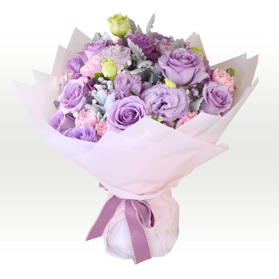 A bouquet of RADIANT BLOOMS TRIO wrapped in white paper by VWOWGIFTS.