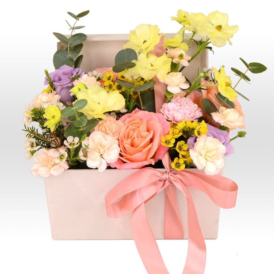 A VWOWGIFTS SUNSET ROMANCE FLOWER BOX with a pink ribbon.