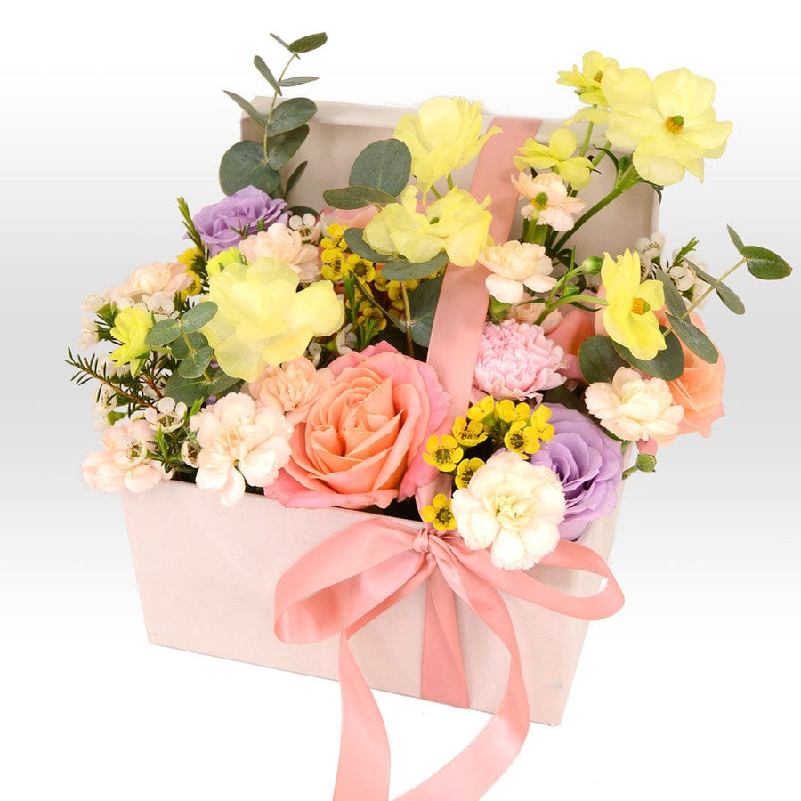 A pink and yellow SUNSET ROMANCE FLOWER BOX arrangement in a white VWOWGIFTS box.
