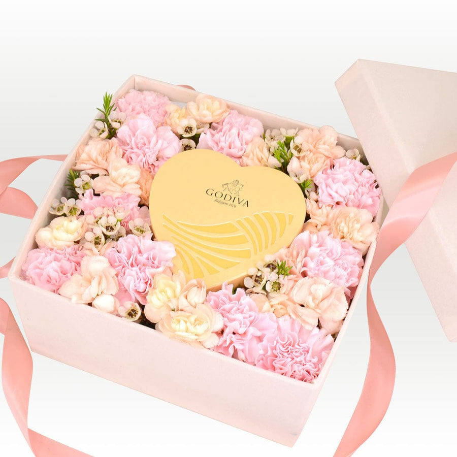 A VWOWGIFTS Sweet Carnation Flower Gift Box filled with pink and white flowers.