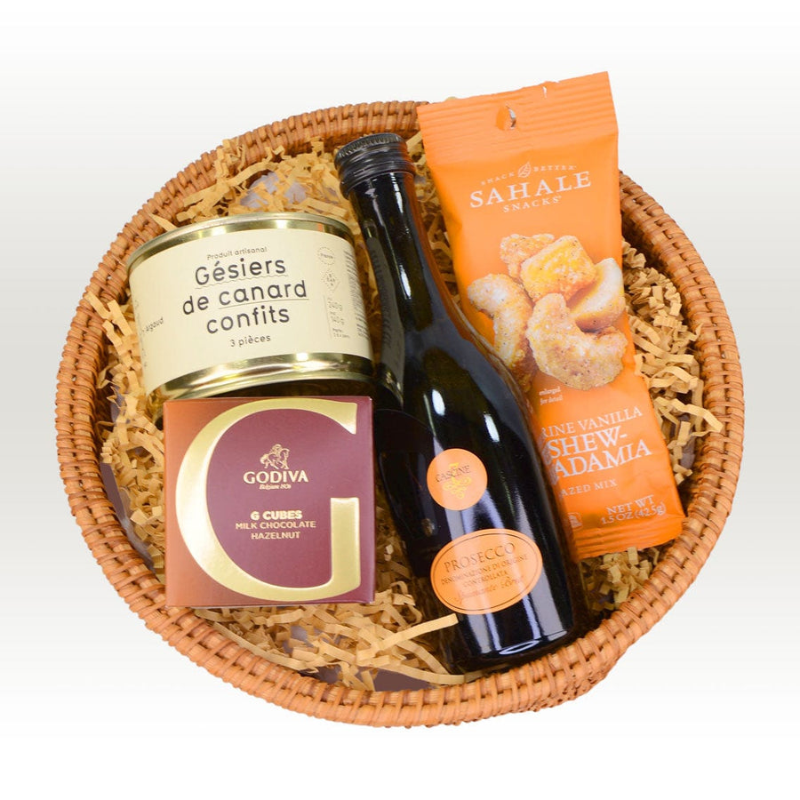 A LEISURELY DELIGHTS HAMPER by VWOWGIFTS with a bottle of wine and snacks.