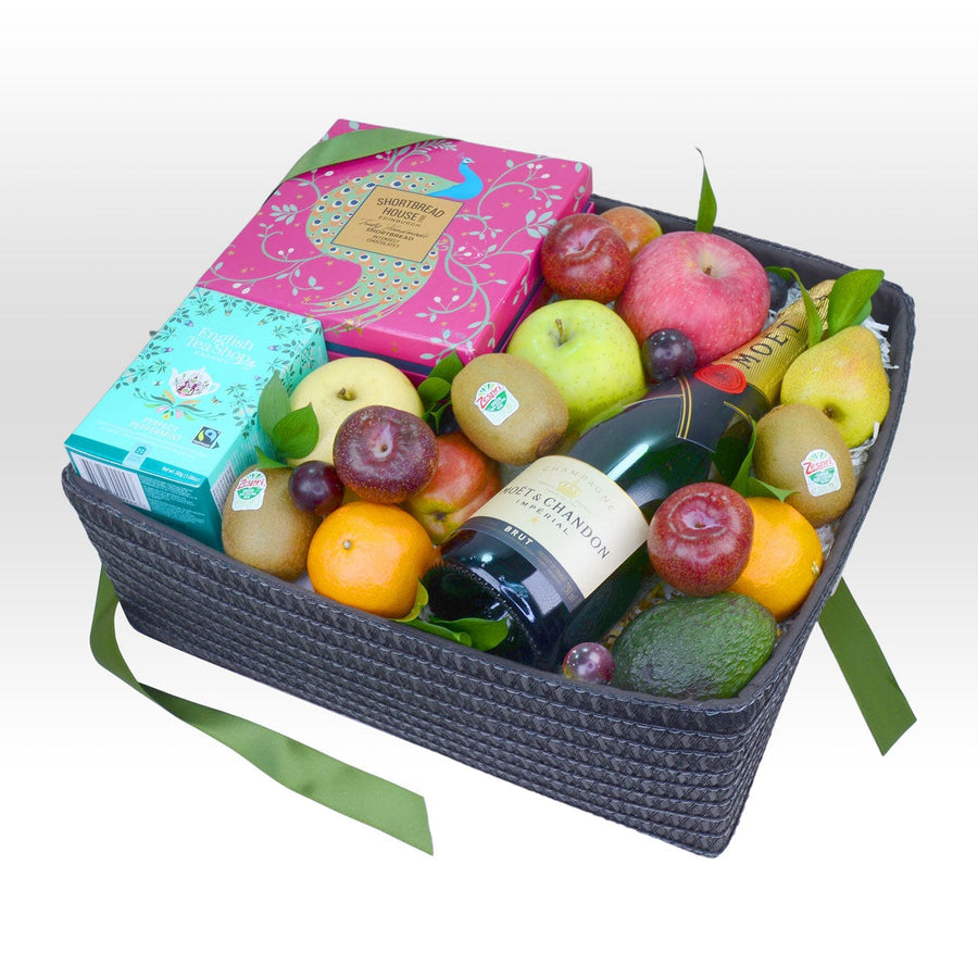 A wicker basket filled with a FRUITFUL CHEERS hamper from VWOWGIFTS