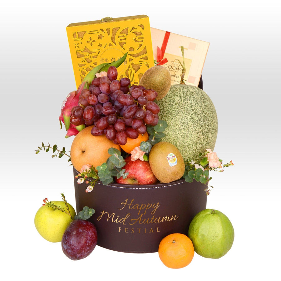 A box of ABUNDANT HARVEST MID-AUTUMN FRUIT HAMPER WITH IMPERIAL PATISSERIE MOONCAKE by VWOWGIFTS and a box of chocolates.