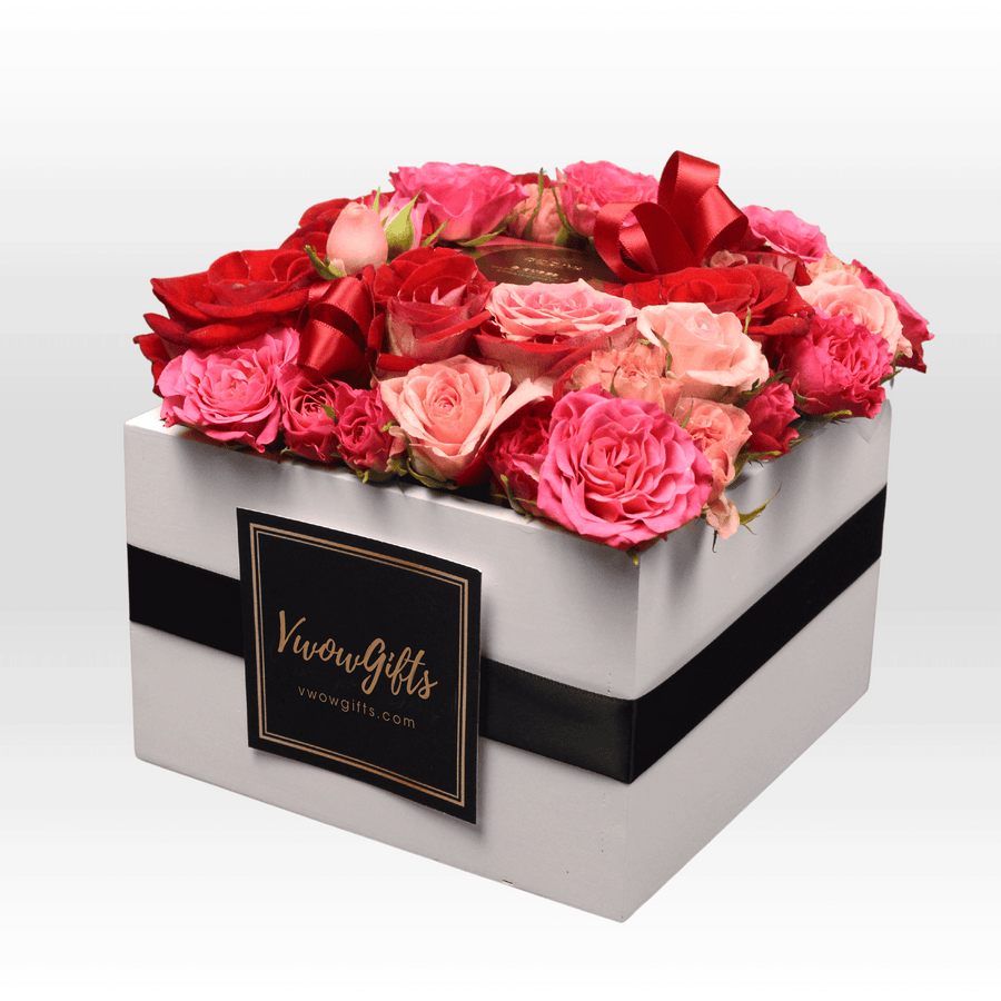 A VWOWGIFTS ROSE DANCE BOX filled with pink and red roses.