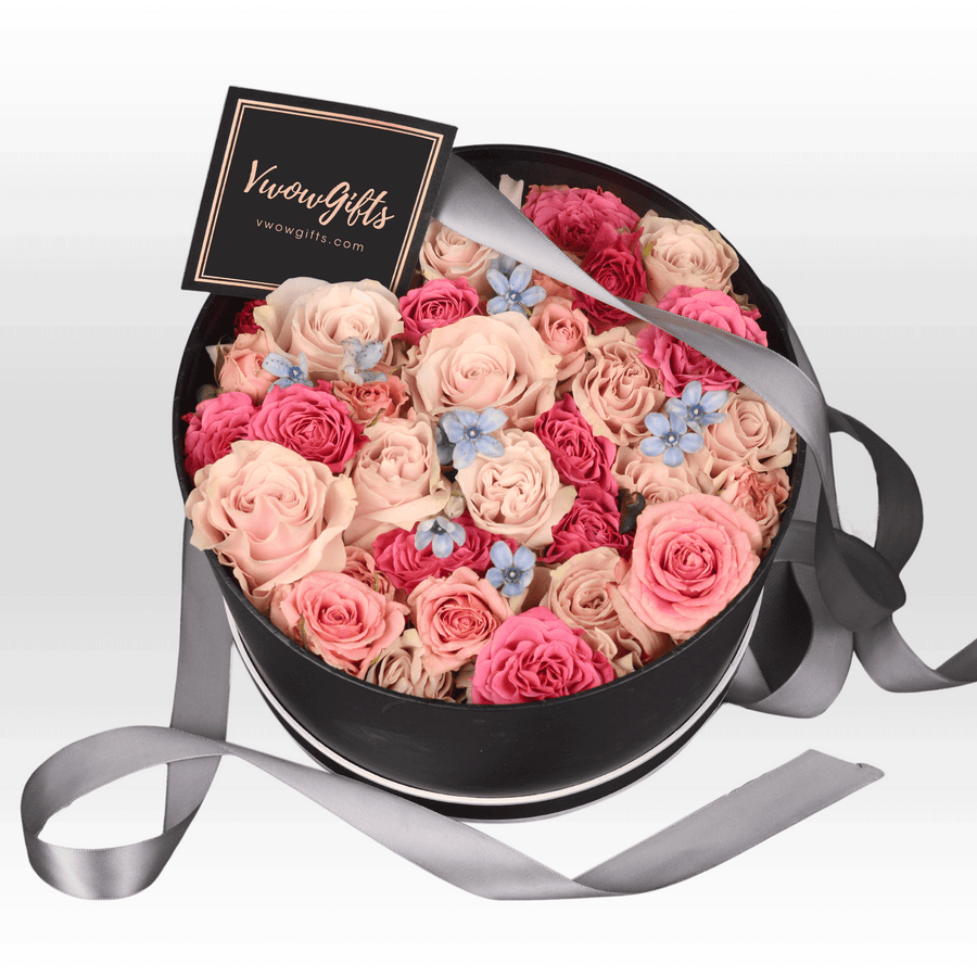 A black box filled with PASTEL PERFECTION roses, by VWOWGIFTS.