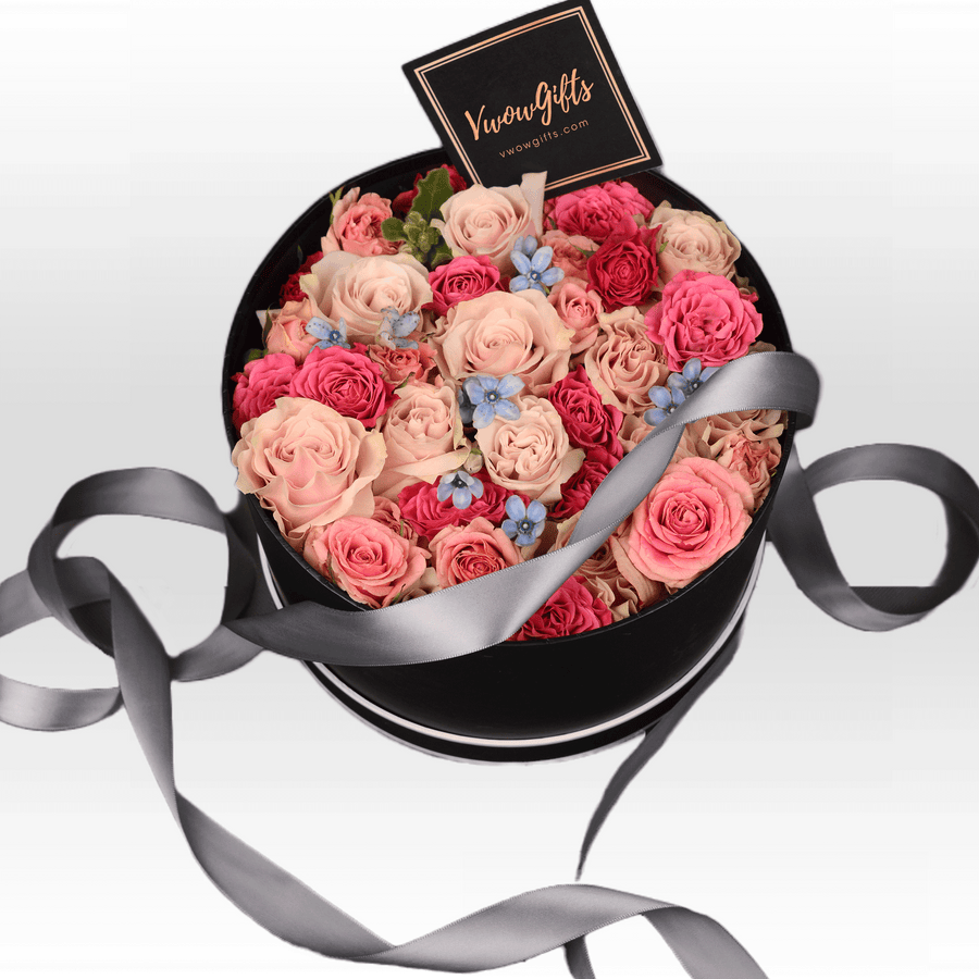 A black box filled with PASTEL PERFECTION roses from VWOWGIFTS.