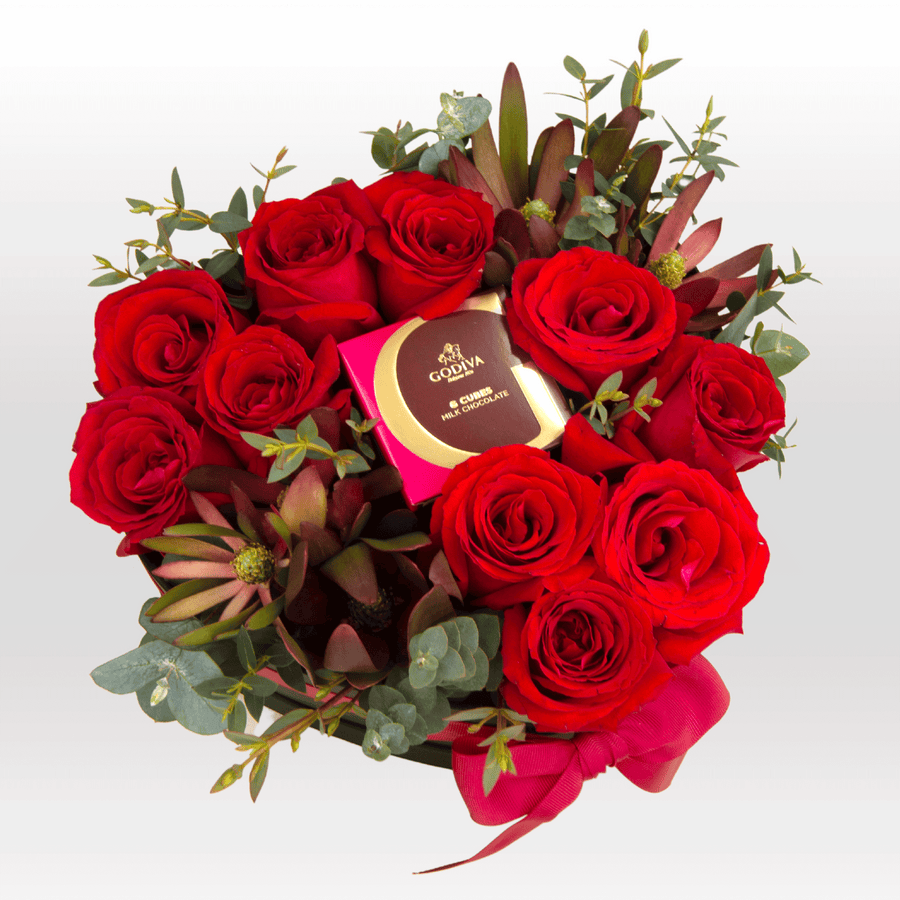 A bouquet of VWOWGIFTS Sweetheart roses with eucalyptus and chocolate.