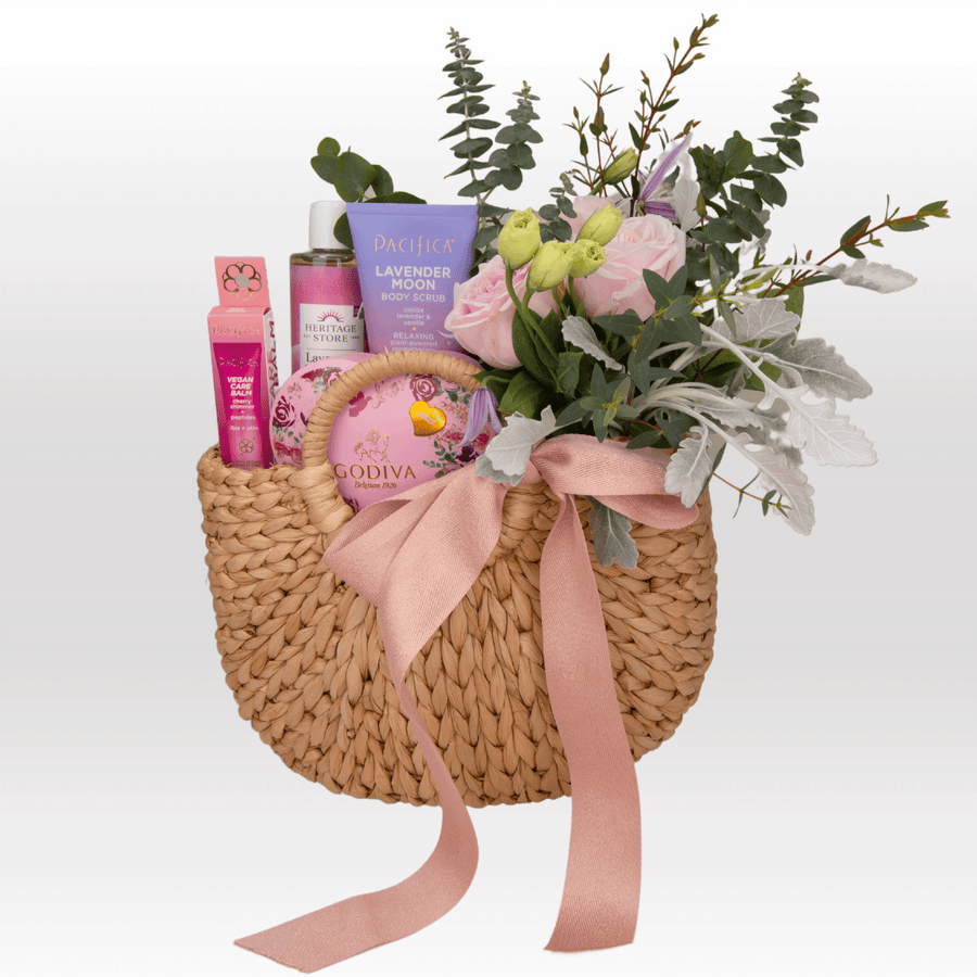 A wicker basket filled with REJUVENATING MOMENT products and flowers from VWOWGIFTS.