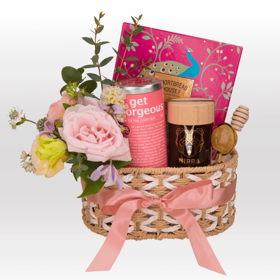A MODERN ROMANTICS wicker basket with flowers and a book by VWOWGIFTS.
