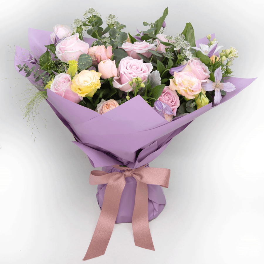 A bouquet of JUST FOR YOU roses wrapped in purple paper from the VWOWGIFTS brand.