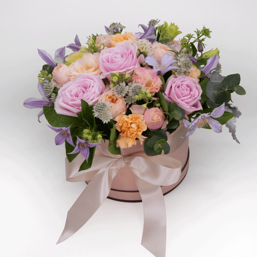 A pink box filled with MAGIC HOUR roses and lilies by VWOWGIFTS.
