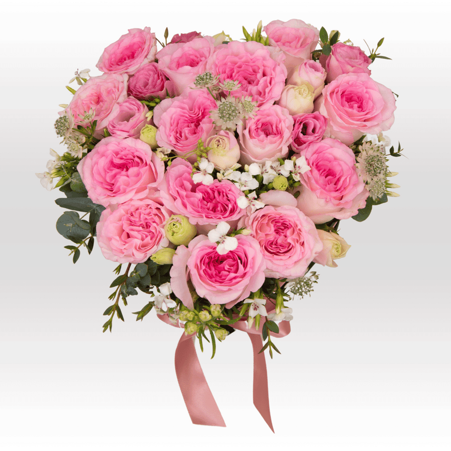 A bouquet of PASTEL LOVE pink roses in a heart shape from VWOWGIFTS.