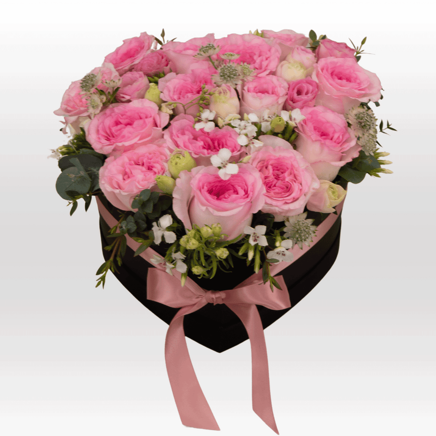 A heart shaped arrangement of pink roses in a black box called PASTEL LOVE by VWOWGIFTS.