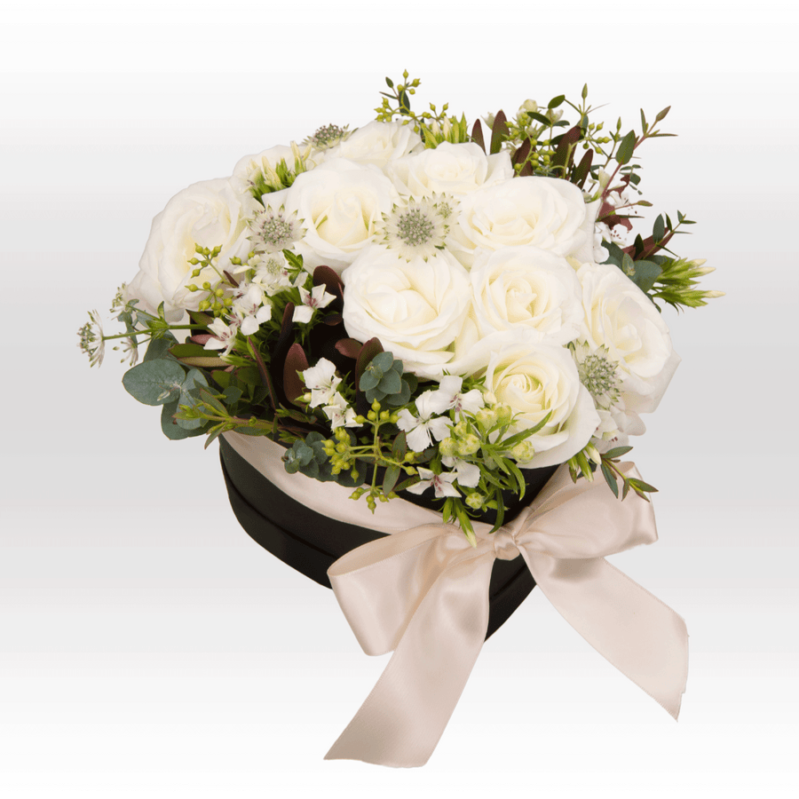 A bouquet of PURE LOVE white roses in a black box by VWOWGIFTS.