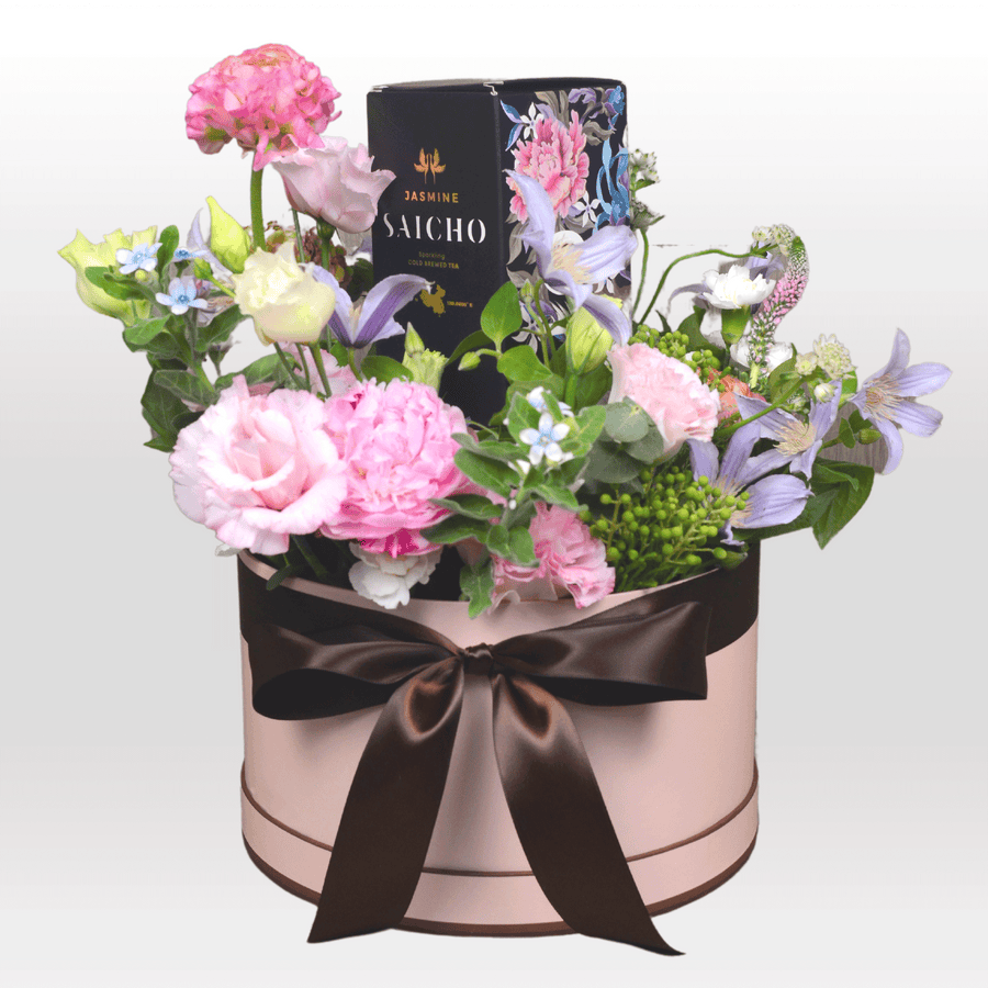 A VWOWGIFTS pink box filled with SPRING INTO SUMMER FLOWER GIFT SET flowers and chocolates.