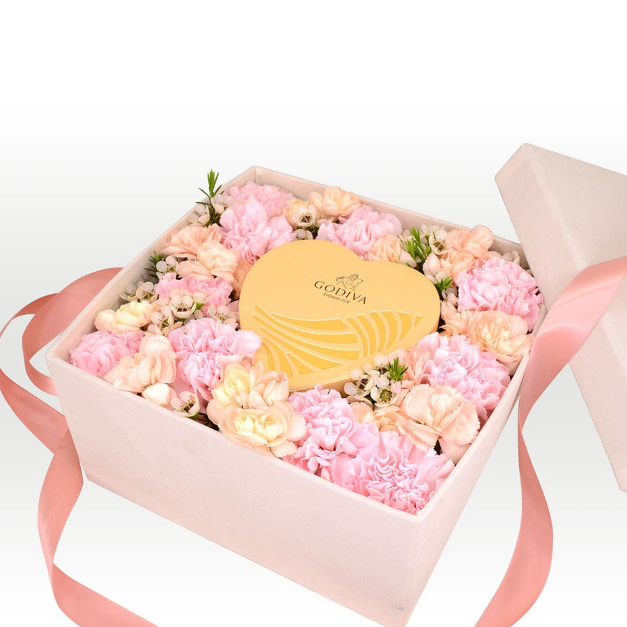 A VWOWGIFTS heart shaped box filled with SWEET CARNATION FLOWER GIFT BOX and a heart shaped chocolate.