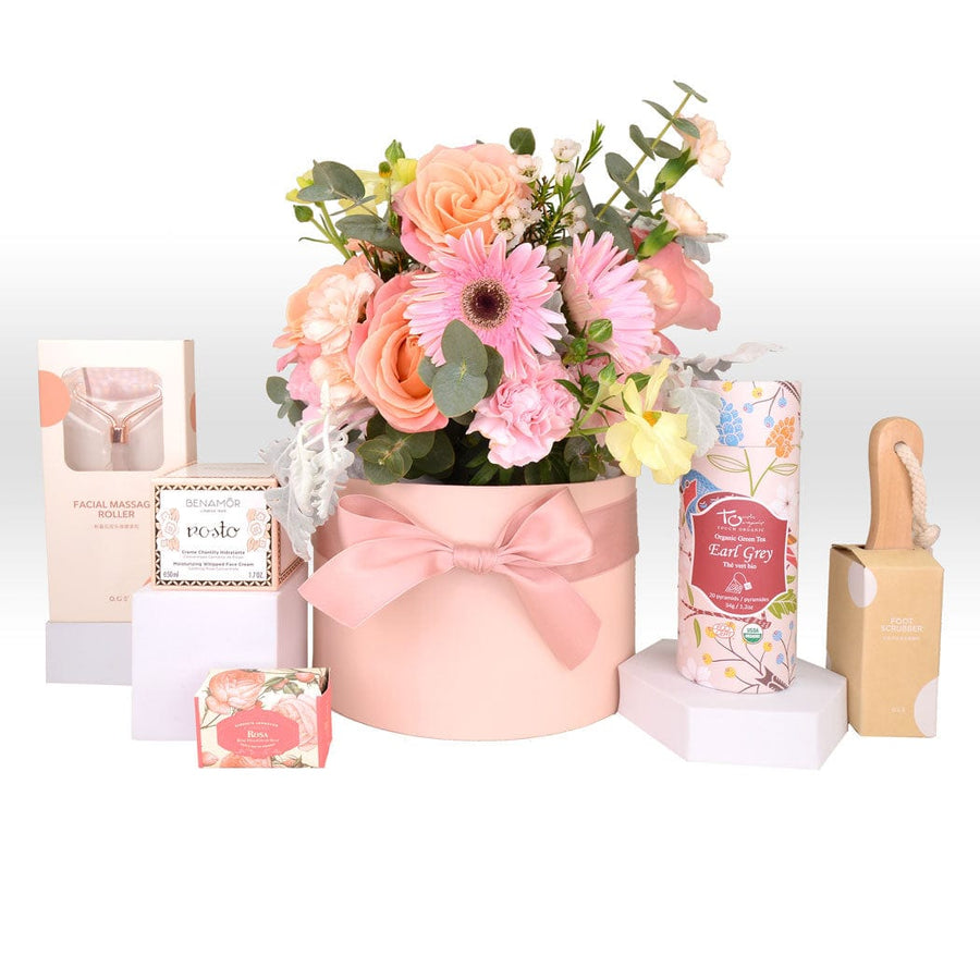 A pink SKINCARE RADIANCE FLOWER GIFT BOX from VWOWGIFTS with flowers, soaps and other items.