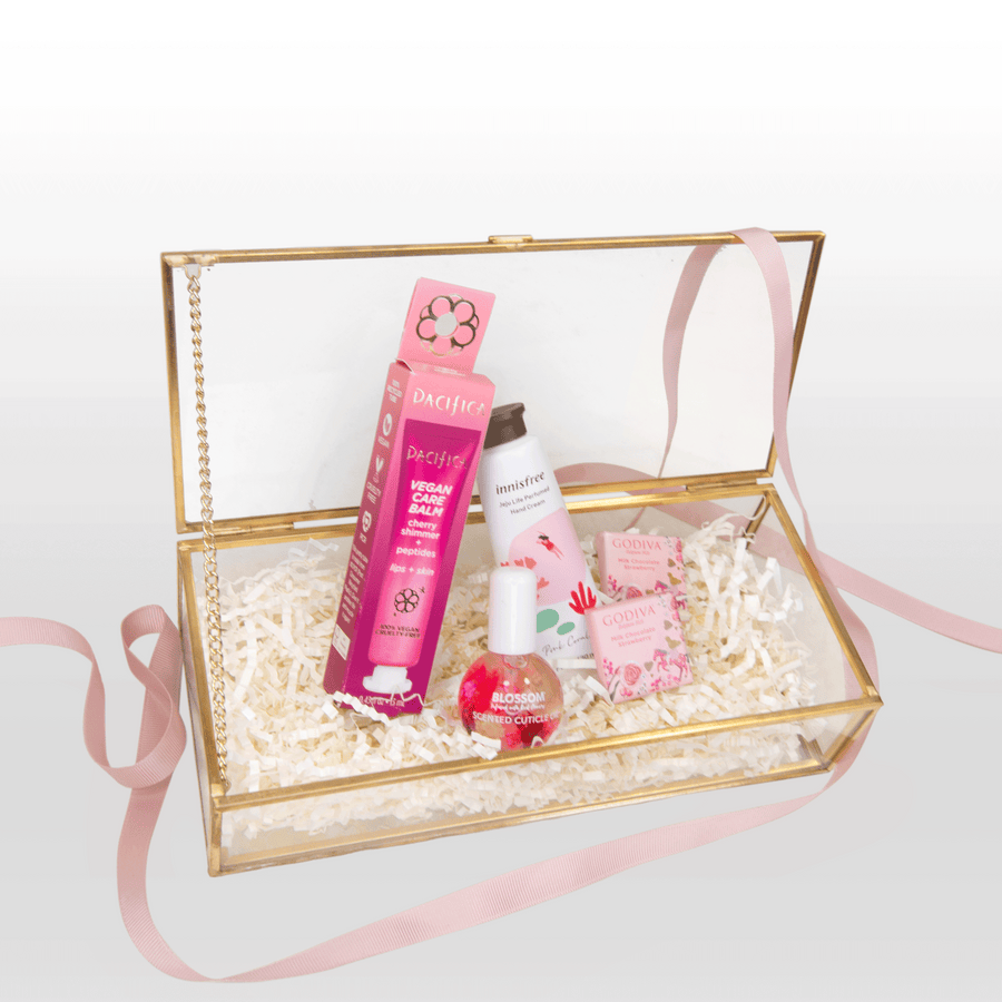 A pink box filled with RELAX & RECHARGE cosmetics and a pink ribbon from VWOWGIFTS.