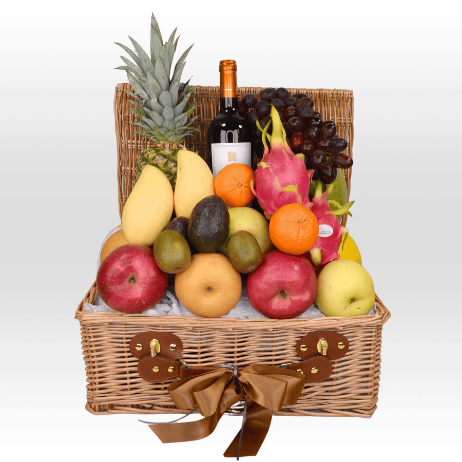 A THE SEASONS FRUIT BASKET filled with fruit and a bottle of wine.